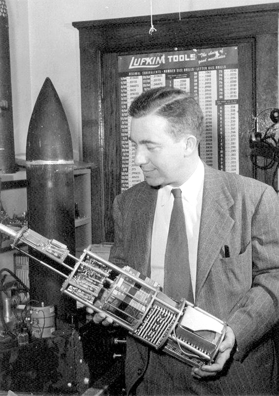 James A. Van Allen holding a piece of technology in the 1950s