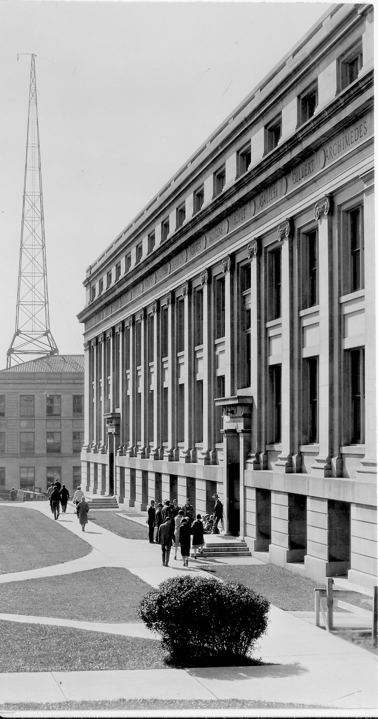 People walking past MacLean Hall in the 1920s